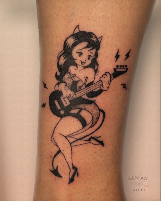 Tatouage d’une pin-up aux petites cornes et à la queue de diablesse jouant de la guitare électrique.